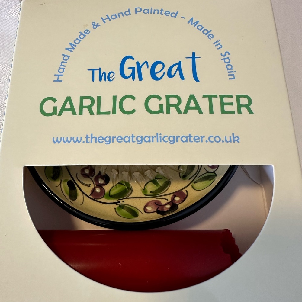 - Hand Painted Ceramic Grater with Red Silicone Sleeve.  New, in original box.